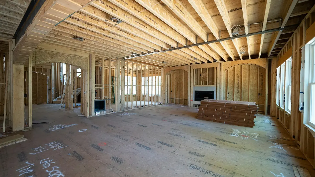 Interior of a home under construction with exposed wood framing