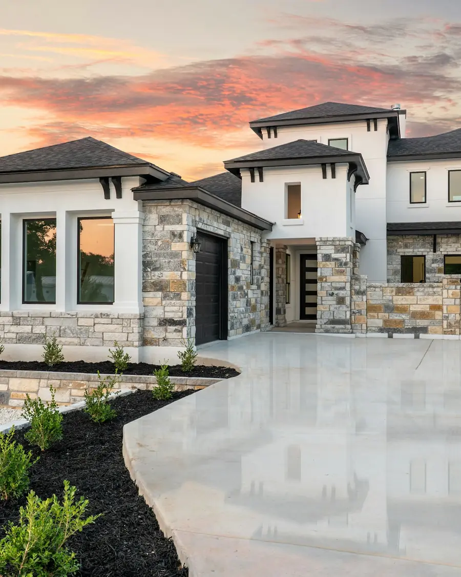 Stone and stucco custom home at sunset